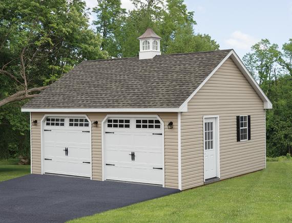 2 car garage with tan siding and cupola