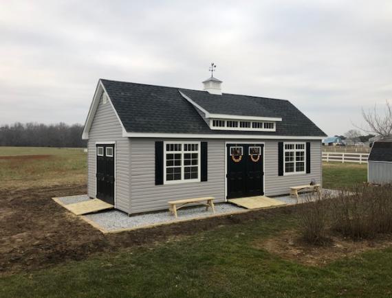 elite classic cottage with two double doors, dormer, cupola, and two ramps