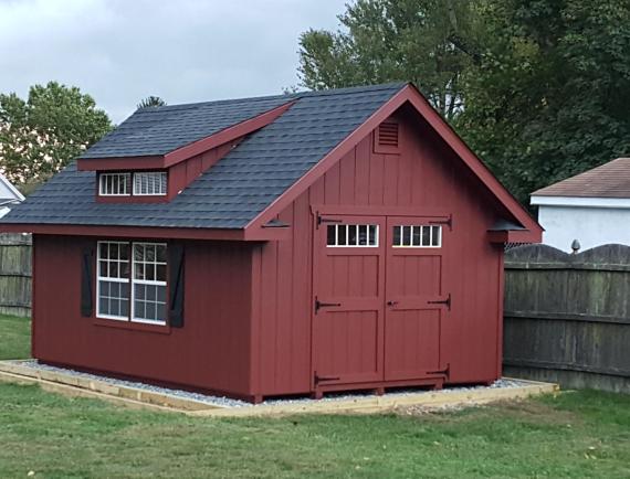 deluxe classic cottage shed with red siding and dormer