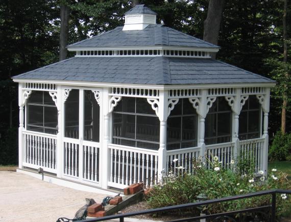 White vinyl rectangle gazebo with ornate details and cupola